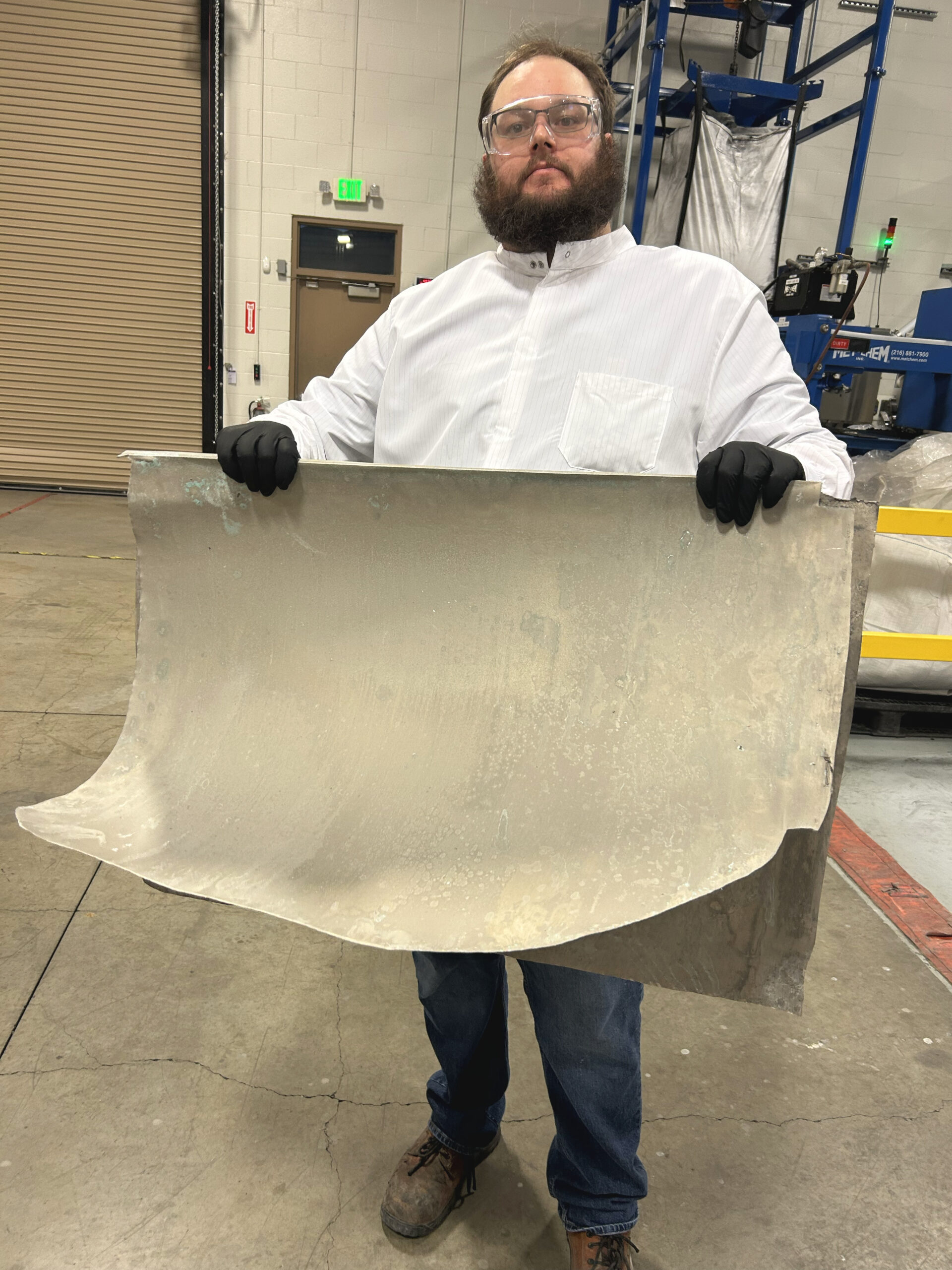 • Aqua Metals engineer with sheet of recycled nickel recovered via sustainable AquaRefining technology